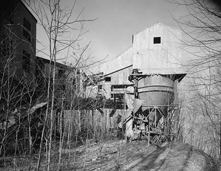 historic photo of an elevated mining building with a large metal bin underneath