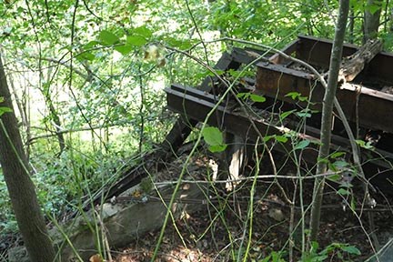 metal ruins of an old building lay on the side of a steep slope