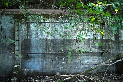concrete wall with metal brackets and rods