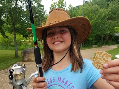 young girl with her Junior Ranger Angler badge