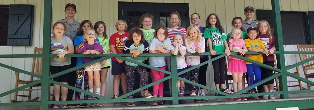 Girl Scouts on cabin porch