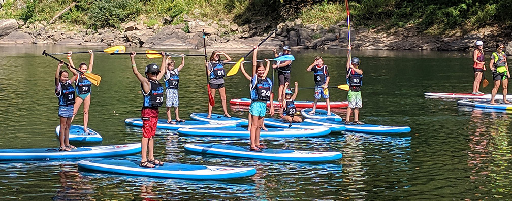 kids on stand-up paddle boards