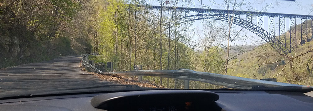 view through windshield of road and bridge