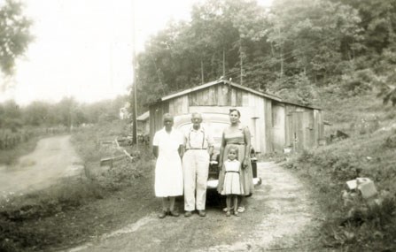 people standing in front of house