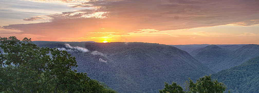 sun setting over a deep gorge