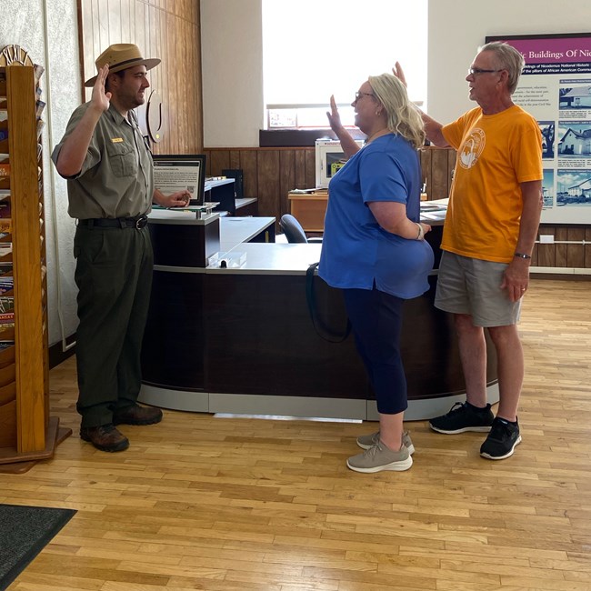 Two people standing in front of a ranger