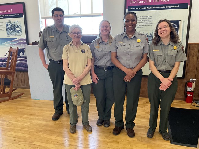 Rangers and volunteer standing together