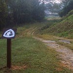 Walking trail with a sign in the left foreground