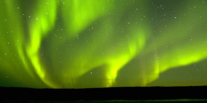 Brilliant green northern lights in the sky