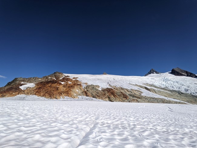 A rock band dissects two sections of the Sulphide Glacier