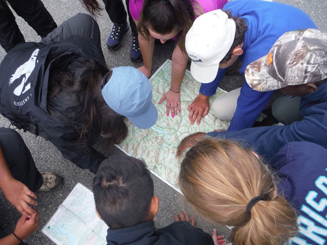 A group looks over a map of the park