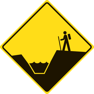 Diamond shaped yellow warning sign with a hiker above a drainage