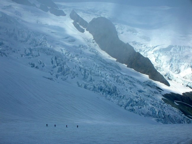 Four climbers crossing glacier