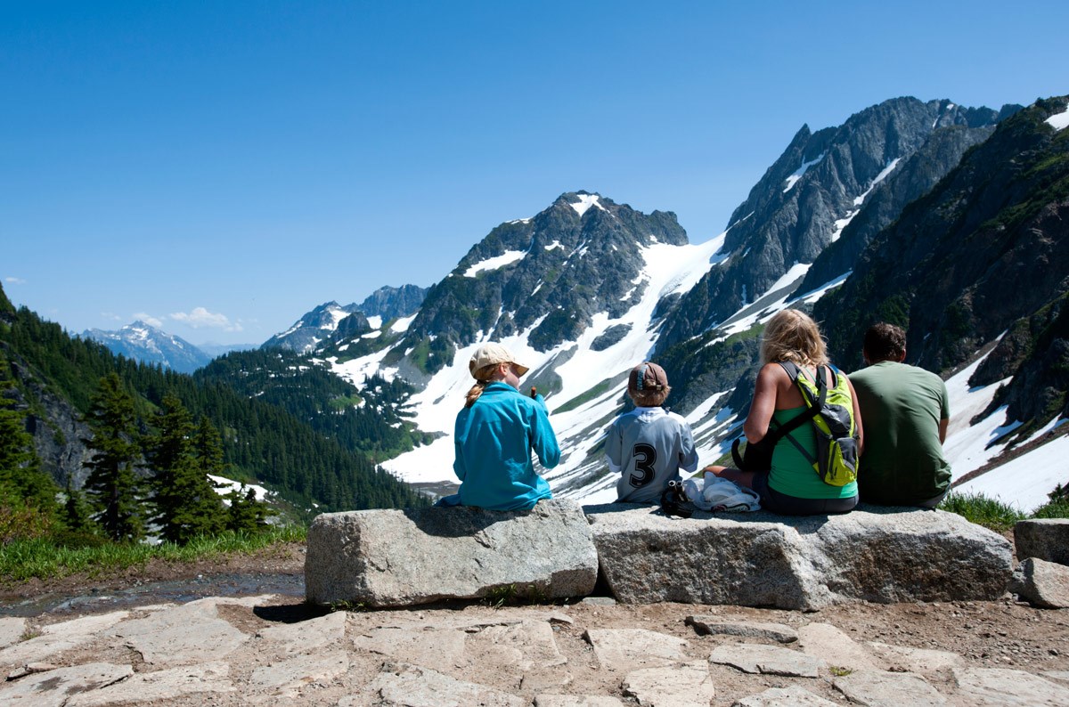 Family resting together at Cascade Pass. NPS/Deby Dixon