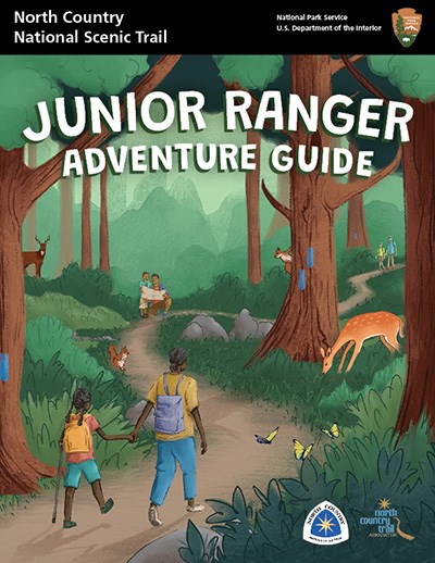 Cover of the junior ranger book showing hikers on a path through woods.