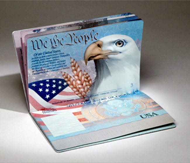 US Passport booklet which is open and showing an American Eagle and Flag.