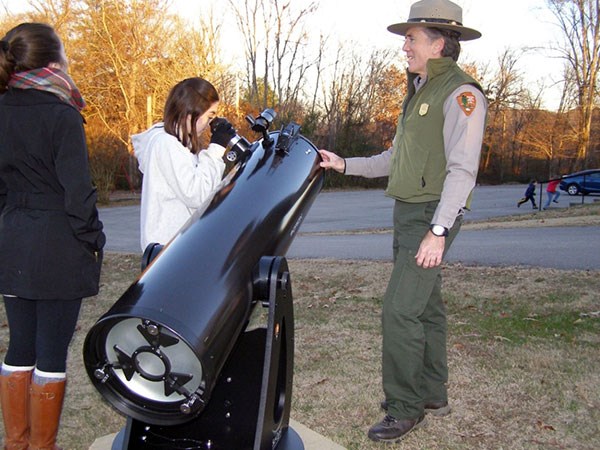 Park ranger with telescope