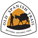 A triangle with "Old Spanish Trail" and a silhouette of a man walking in front of a pack burro.