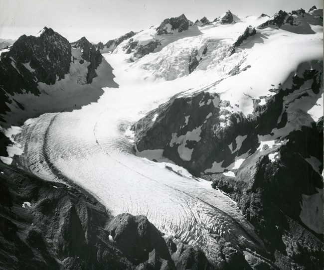 Black and white photograph of a massive mountain glacier