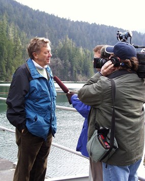 Former Secretary of the Interior Babbit visiting Glines Canyon Dam in 2000. A journalist and cameraman conduct an interview of Babbit.