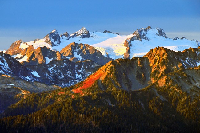 Sunrise on glacier capped mountains.