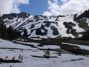 A mountain basin mostly covered in snow.