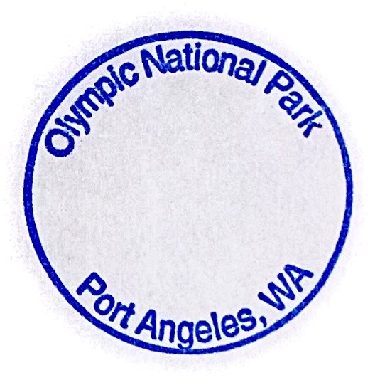 A photo of the circular cancellation stamp with the text "Olympic National Park Port Angeles, WA" in blue ink.