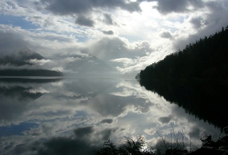 Thick clouds reflect upon the still waters of Lake Crescent.