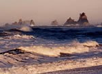ocean waves with rocky islands in background