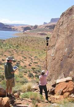 Two people perform photogrammetry.
