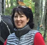 Leslie standing by horse-logging in the park