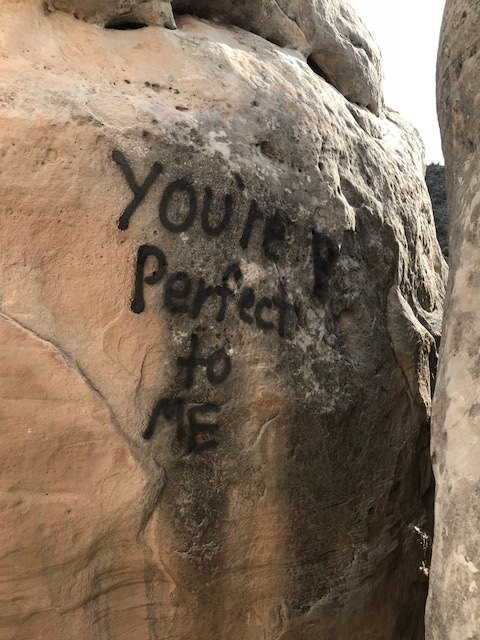 One of several rock walls in Colorado National Monument defaced by vandalism. NPS photo.