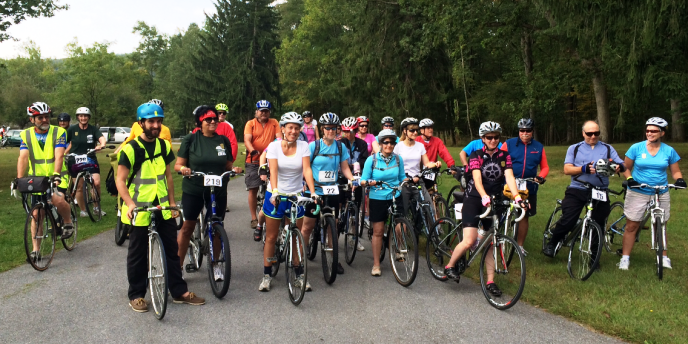 Group of cyclists stop for a photo along the trail