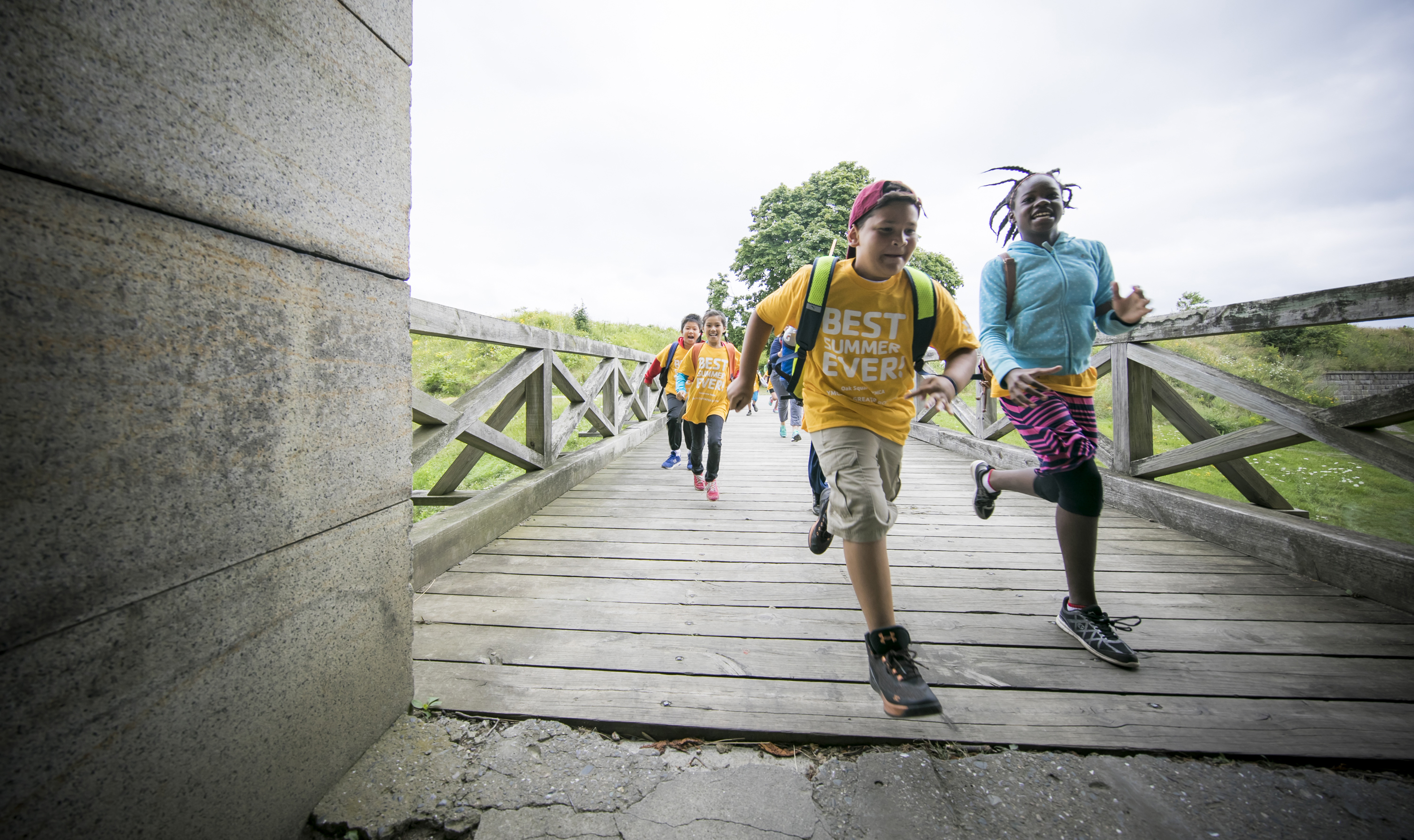 Young girls and boys running along a path.