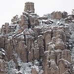 Tall rock spires with a dusting of snow.