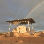 Casa Grande ancient earthen dwelling with a rainbow above