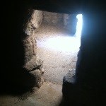 A t-shaped doorway shows light from a second, outer doorway on the floor beyond.