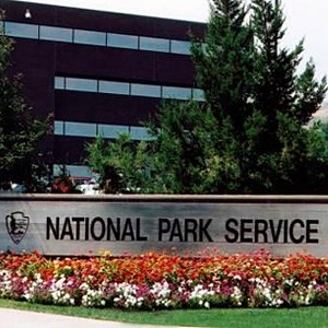 photo of the Denver Service Center building with a National Park Service sign and flowerbed in the foreground.