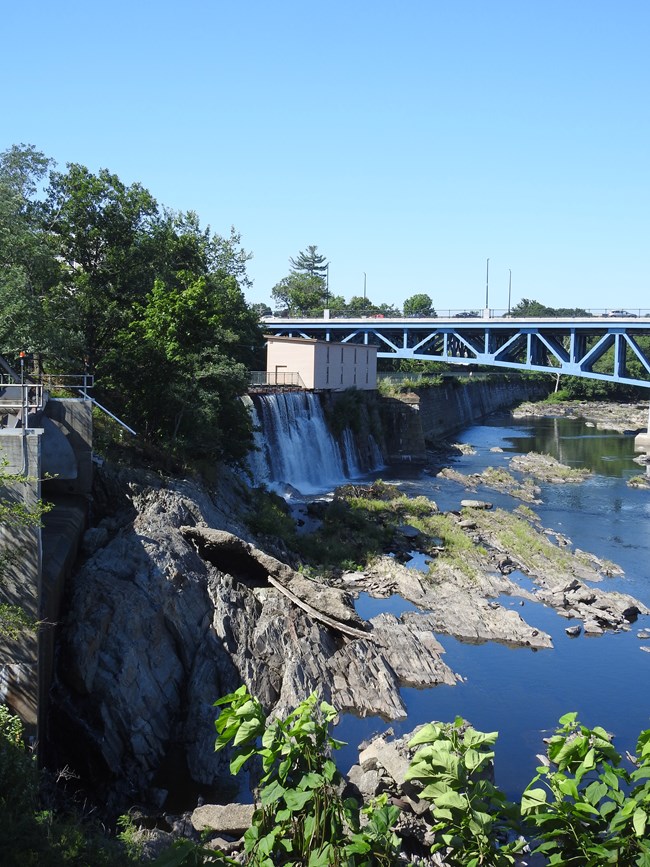 The hydroelectric facilities overlooks exposed bedrock in the river channel.
