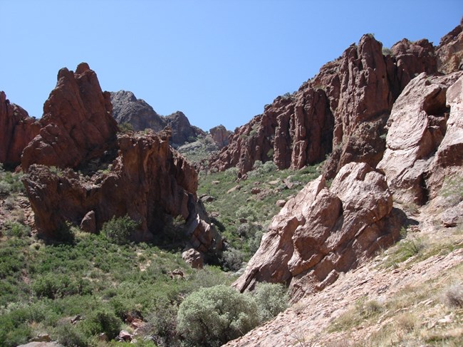 A large canyon, with steep mountain slopes on either side.