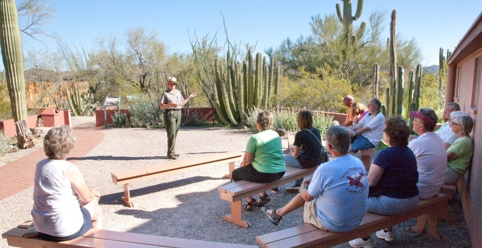 Ranger conducting a patio talk to a crowd at the visitor center