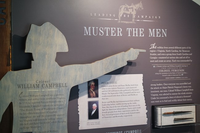 A sign reading "Muster the Men" with more text and images of old paintings