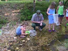 Bill O'Donnell in creek with kids