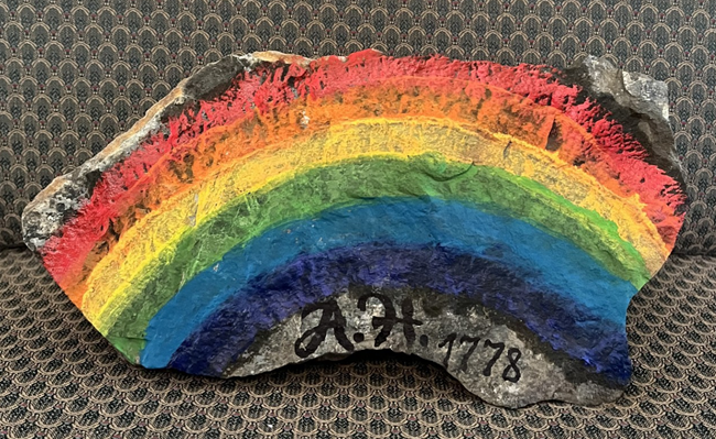 Grey Basalt rock with a rainbow and the initials A H under