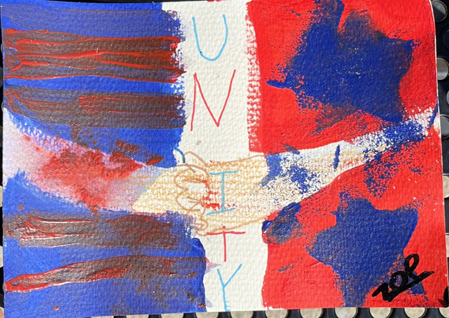 Blue, white and red flag with UNITY writing on the white