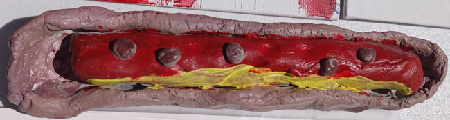 Hot dog in a bun with mustad and chili