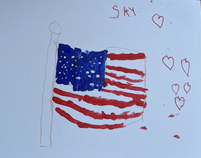 American flag on flag pole with hearts around it