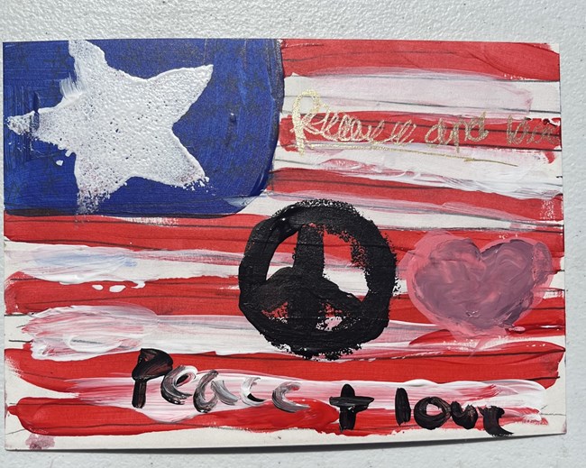 American flag with a peace sign and heart