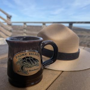 A coffee mug and ranger hat