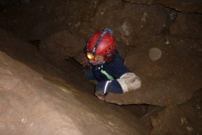 Image of a man exploring Bloomington Cave. Saint George BLM Field Office